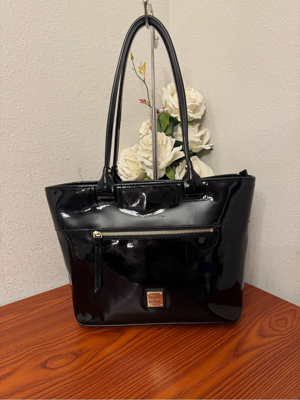 Dooney & Bourke Black Patent Leather Tote with Front Zip Pocket and Gold Accents